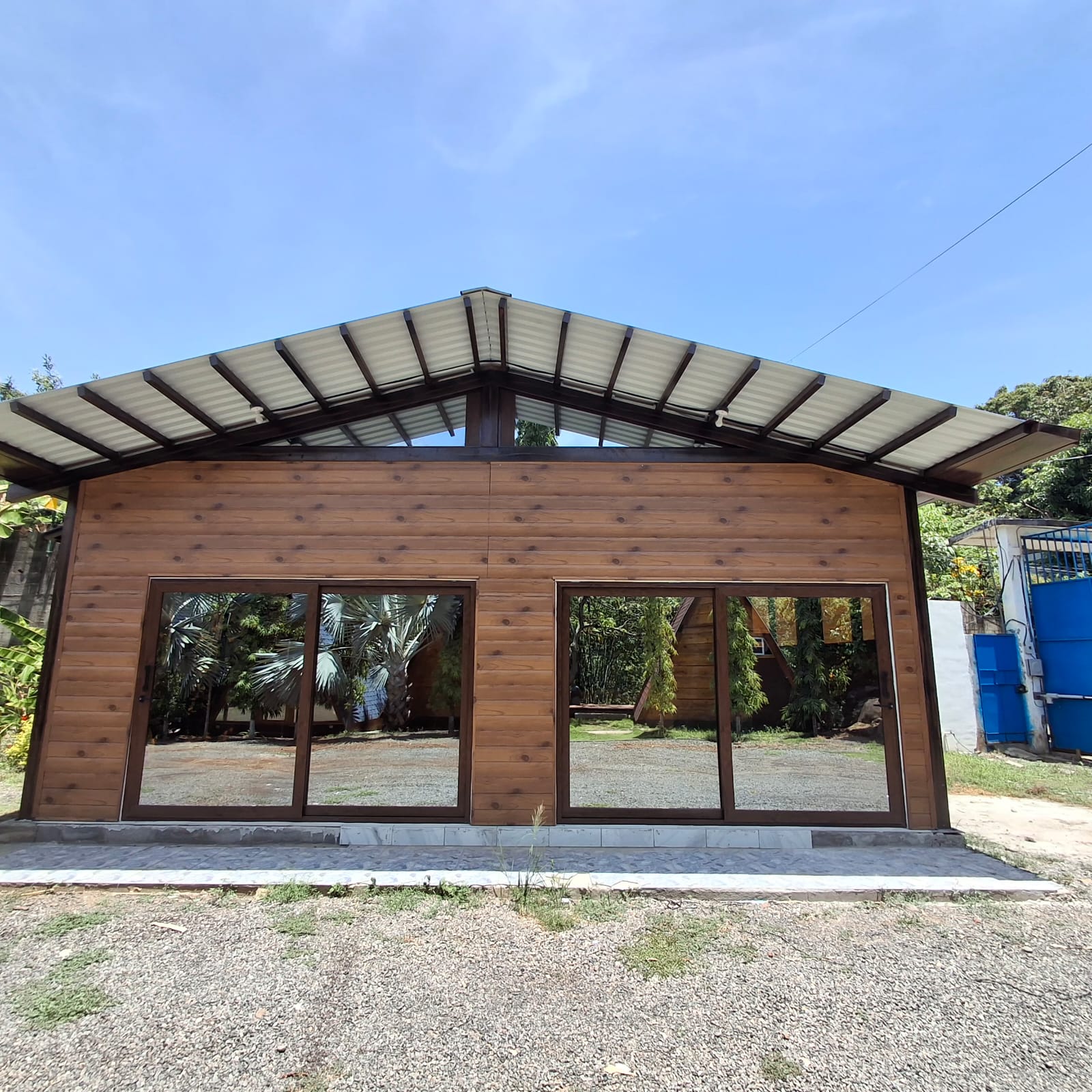 Cubierta metálica terminada sobre una construcción con fachada de madera